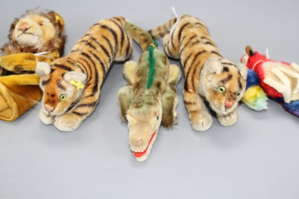 Two 1950s Steiff tigers, a crocodile, a parrot and a lion glove puppet